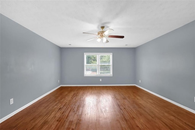 spare room with hardwood / wood-style floors and ceiling fan