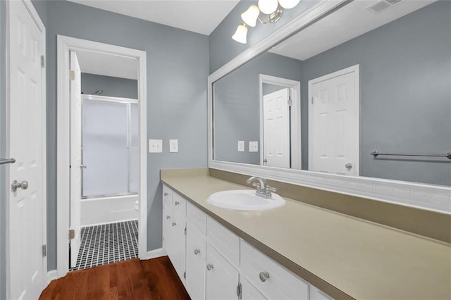 bathroom with shower / bath combination with glass door, vanity, and hardwood / wood-style flooring