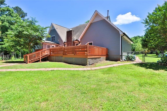 rear view of property with a yard and a deck