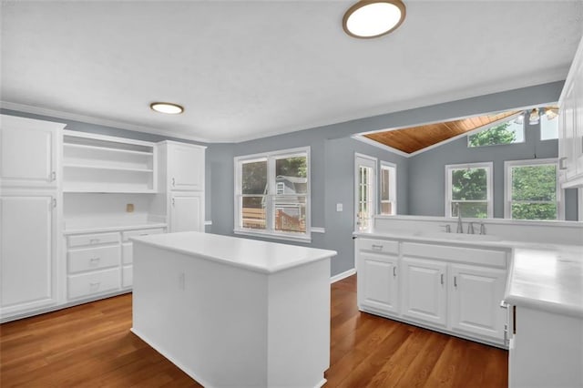 kitchen with a center island, light hardwood / wood-style flooring, white cabinetry, and a healthy amount of sunlight