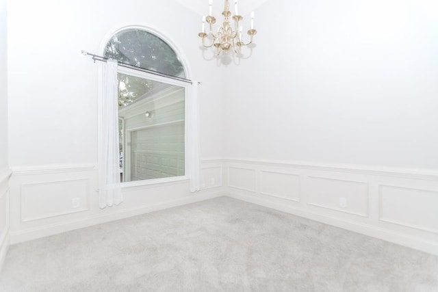 1122 Cayuga Ct, Dacula, GA 30019 - spare room with a chandelier, carpet flooring, a wainscoted wall, and a decorative wall