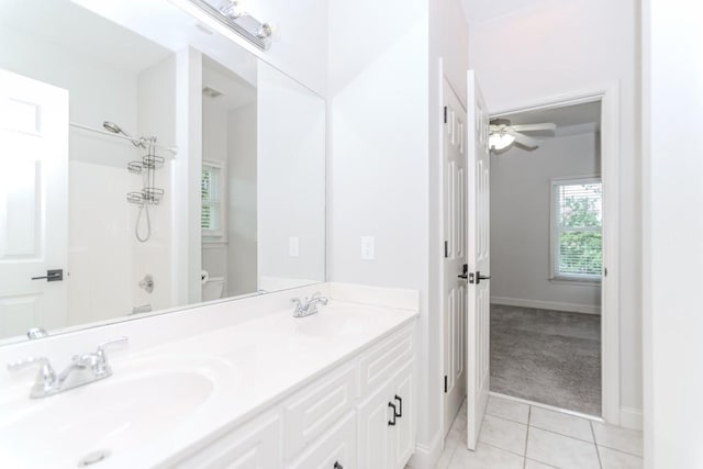 1122 Cayuga Ct, Dacula, GA 30019 - bathroom featuring tile patterned flooring, double vanity, a shower, and a ceiling fan
