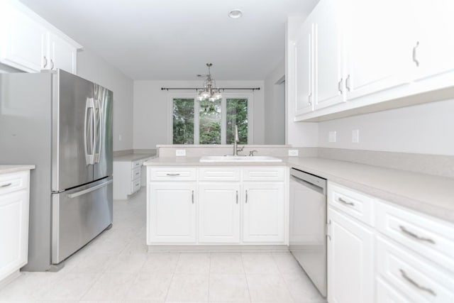 1122 Cayuga Ct, Dacula, GA 30019 - kitchen with stainless steel appliances, light countertops, white cabinetry, light tile patterned floors, and a chandelier
