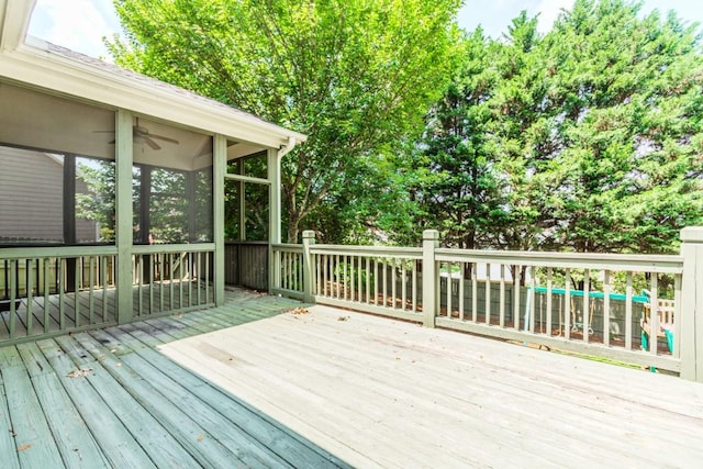 1122 Cayuga Ct, Dacula, GA 30019 - wooden deck featuring a sunroom and ceiling fan