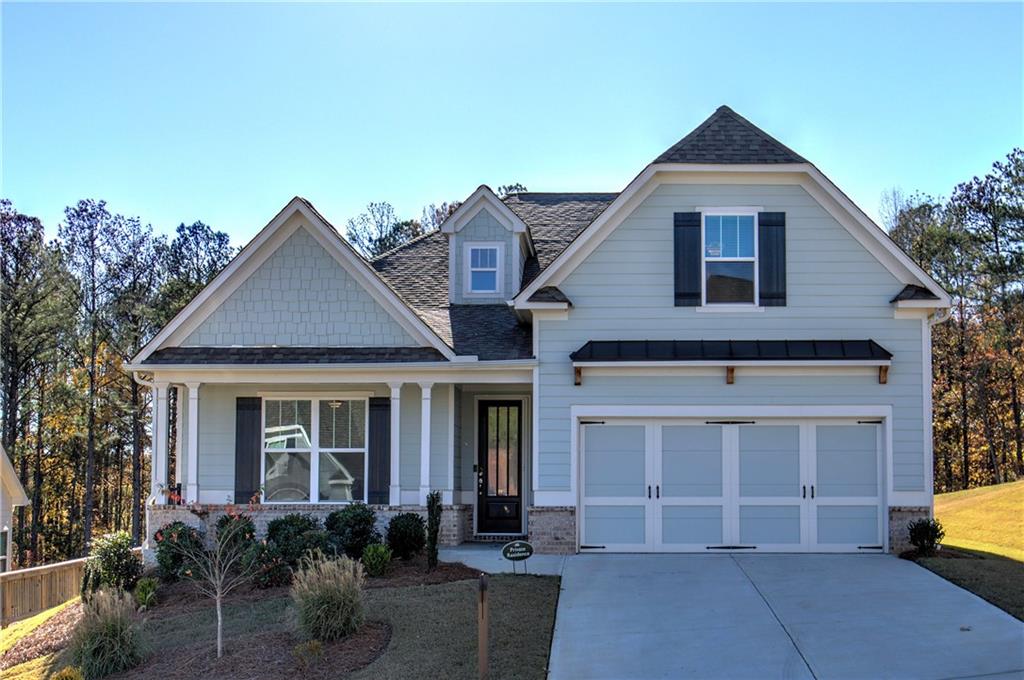 craftsman house with a garage and a front lawn