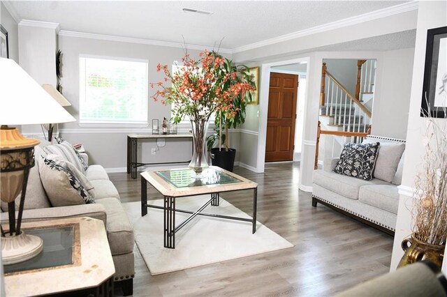 9130 Charlton Pl, Douglasville, GA 30135 - living room with wood finished floors, crown molding, and stairway