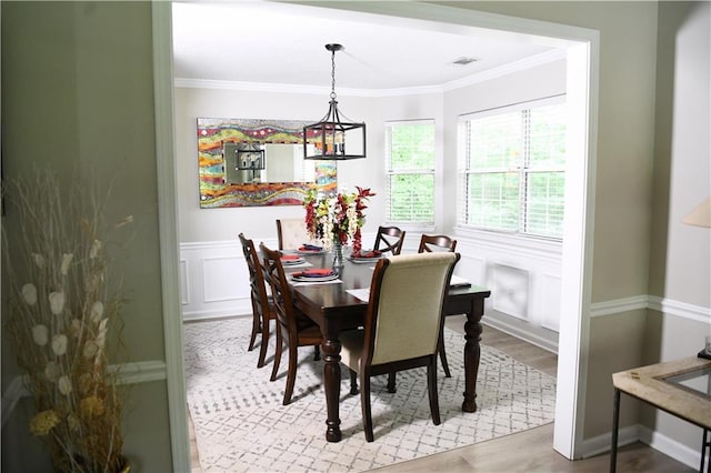 9130 Charlton Pl, Douglasville, GA 30135 - dining space featuring ornamental molding, wood finished floors, a wainscoted wall, and a decorative wall