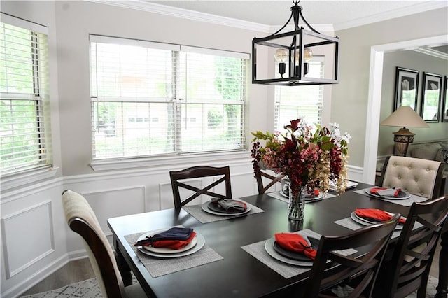 9130 Charlton Pl, Douglasville, GA 30135 - dining room featuring ornamental molding, a decorative wall, a wainscoted wall, wood finished floors, and a chandelier