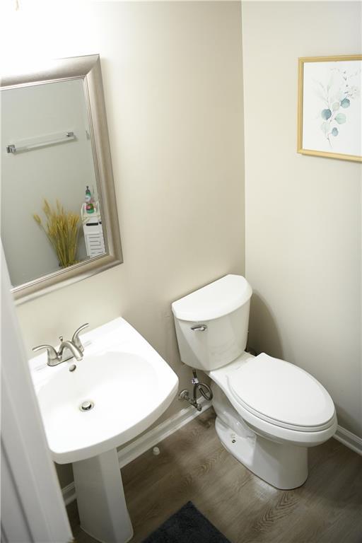 9130 Charlton Pl, Douglasville, GA 30135 - bathroom featuring toilet and wood finished floors