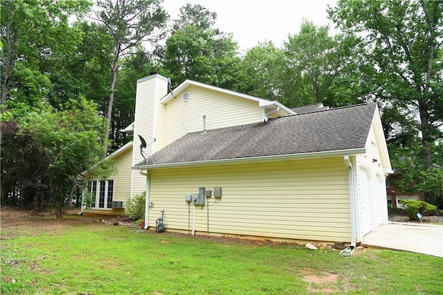9130 Charlton Pl, Douglasville, GA 30135 - view of home's exterior featuring driveway, roof with shingles, a yard, and a chimney