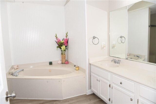 9130 Charlton Pl, Douglasville, GA 30135 - full bathroom featuring a shower stall, vanity, a whirlpool tub, and wood finished floors