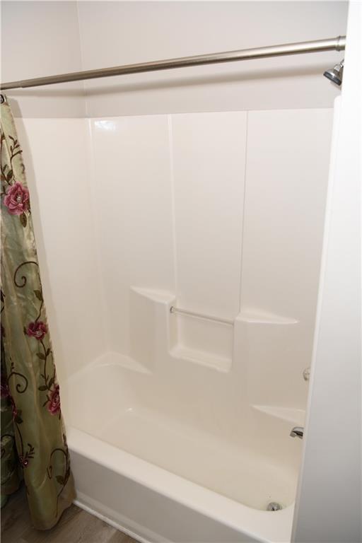 9130 Charlton Pl, Douglasville, GA 30135 - bathroom featuring a garden tub, vanity, and wood finished floors