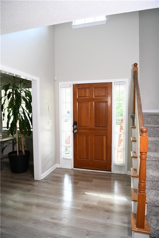 9130 Charlton Pl, Douglasville, GA 30135 - foyer featuring high vaulted ceiling, wood finished floors, and stairs