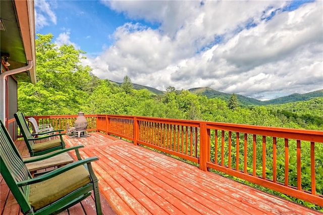 wooden terrace with a mountain view and a wooded view