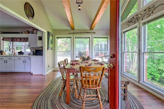 dining space featuring dark wood finished floors and baseboards