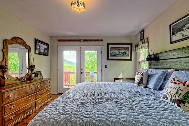 bedroom featuring french doors, access to exterior, and wood finished floors