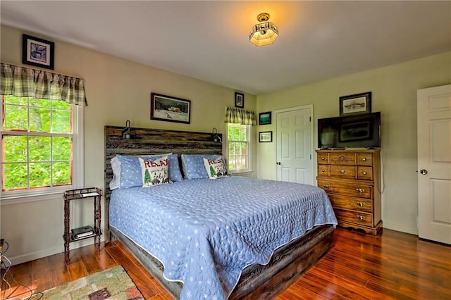 bedroom with wood finished floors and baseboards