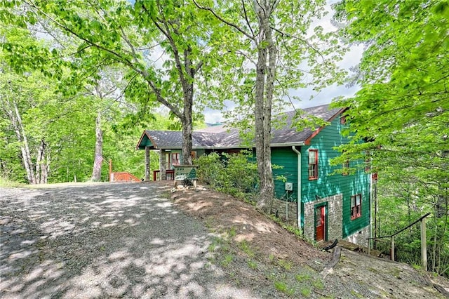view of side of home featuring driveway