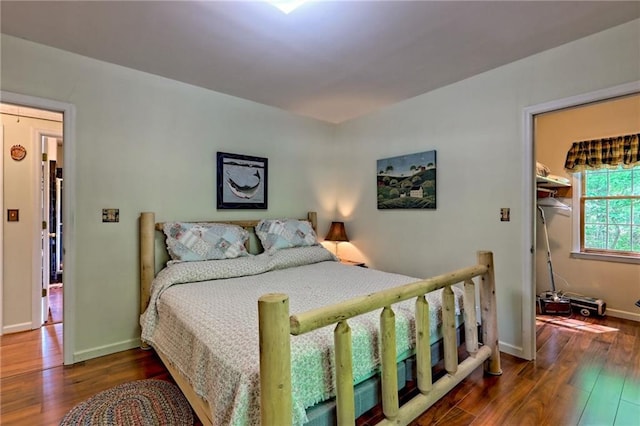 bedroom featuring wood finished floors and baseboards
