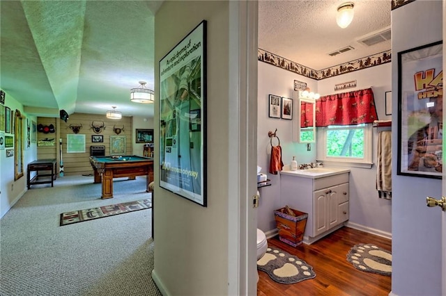 playroom with a textured ceiling, pool table, baseboards, dark wood-type flooring, and a sink