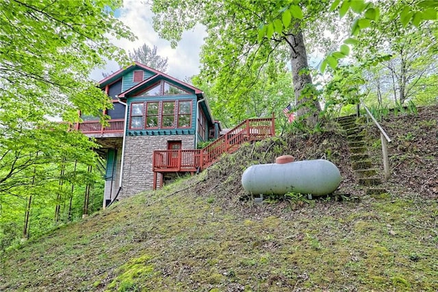 view of playground with a wooden deck and stairs