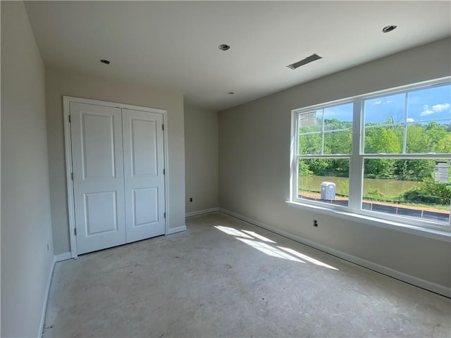 4678 Glore Rd SW, Mableton, GA 30126 - unfurnished bedroom featuring baseboards, concrete floors, and a closet