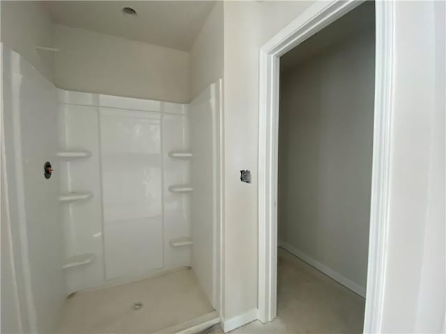 4678 Glore Rd SW, Mableton, GA 30126 - bathroom featuring a stall shower, baseboards, and concrete floors