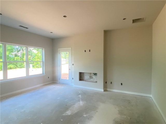 4678 Glore Rd SW, Mableton, GA 30126 - unfurnished living room featuring baseboards and unfinished concrete floors