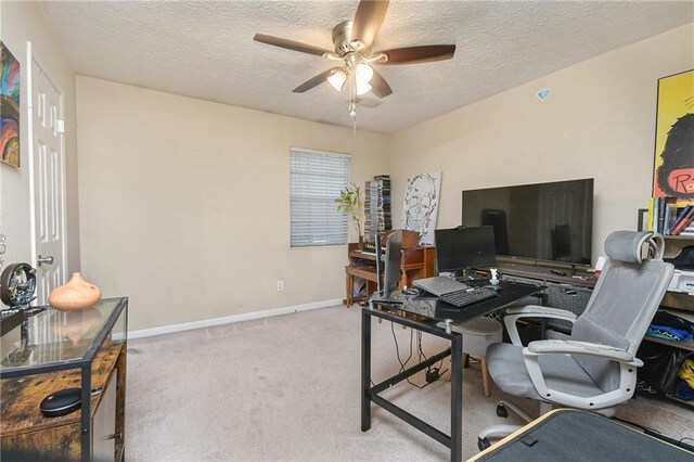 carpeted home office featuring ceiling fan and a textured ceiling