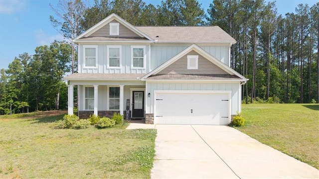 view of front of house featuring a front lawn, concrete driveway, a garage, board and batten siding, and a porch
