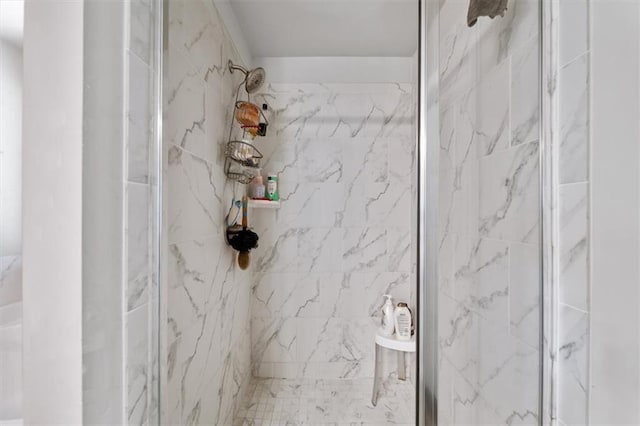 full bathroom with a marble finish shower