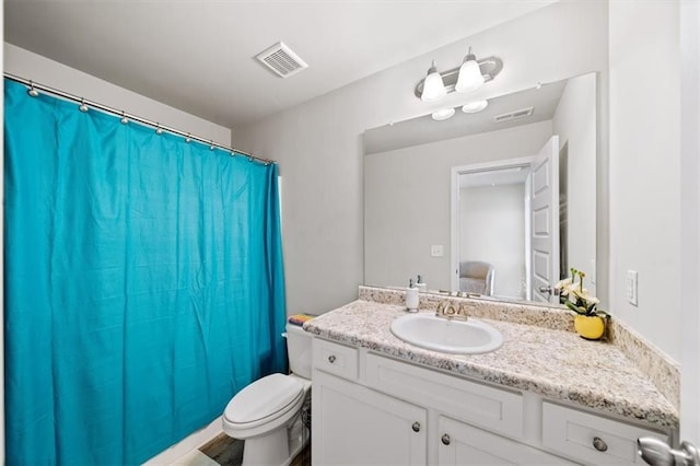 bathroom featuring vanity, toilet, and a shower with curtain