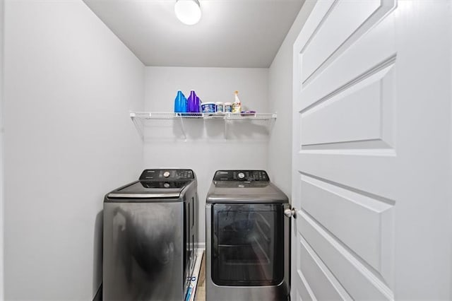 laundry area with washing machine and clothes dryer