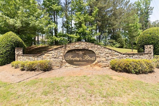 community sign featuring view of scattered trees