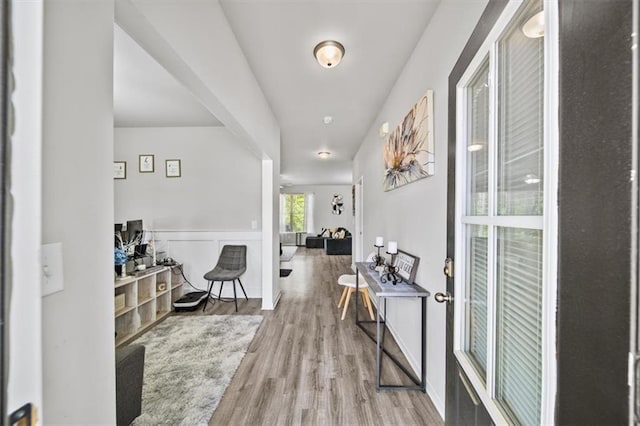 entryway featuring wood finished floors and wainscoting