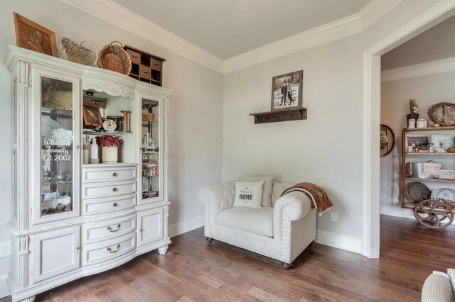 living area featuring crown molding, baseboards, and dark wood-style floors