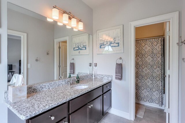 bathroom with vanity, baseboards, tile patterned floors, and curtained shower