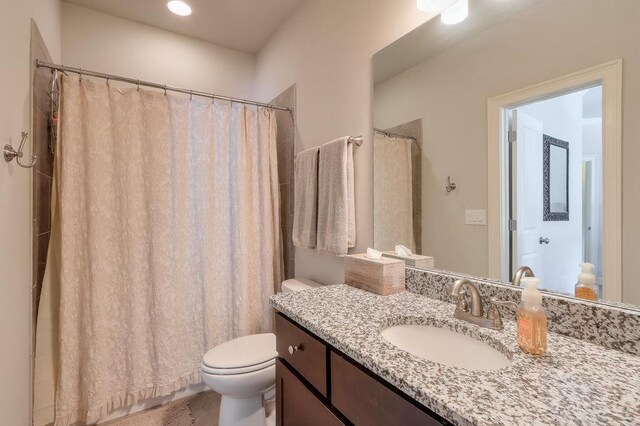 bathroom with toilet and vanity