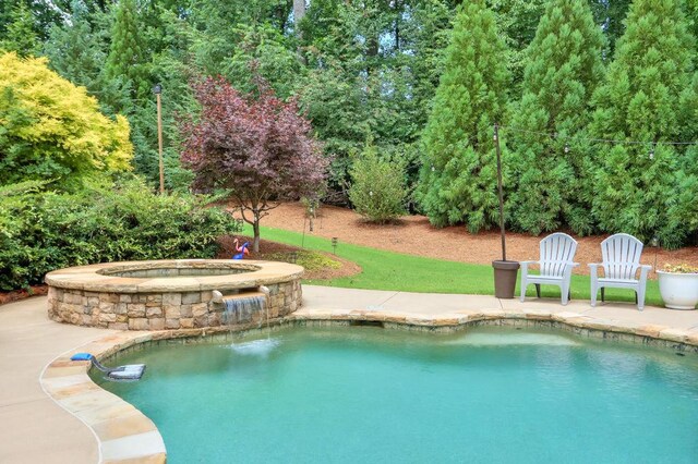 pool with a patio and an in ground hot tub