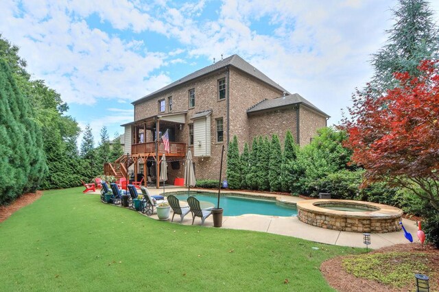 view of swimming pool featuring a lawn, a patio area, stairway, and a deck