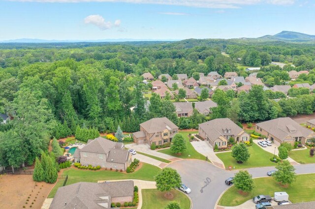 drone / aerial view with a residential view and a view of trees
