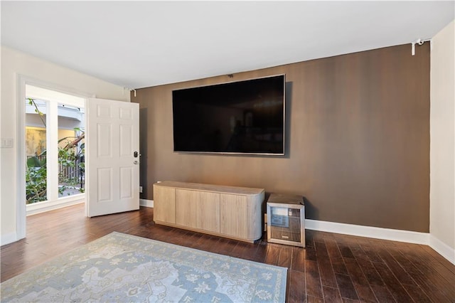 living area featuring baseboards and dark wood-style flooring