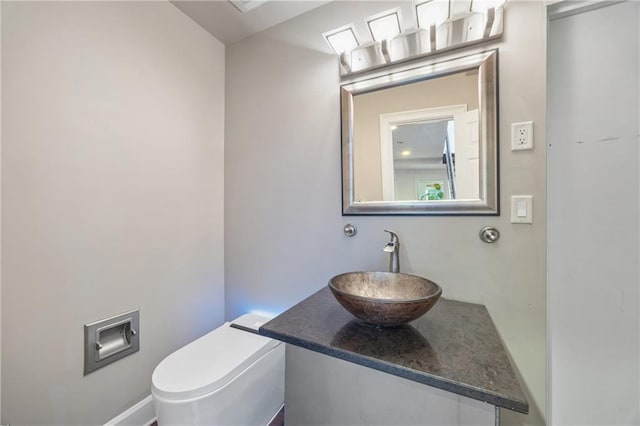 half bathroom with vanity and toilet