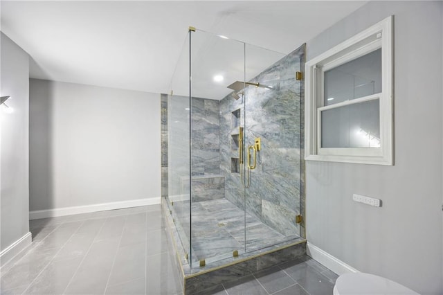 full bath featuring baseboards, toilet, and a marble finish shower