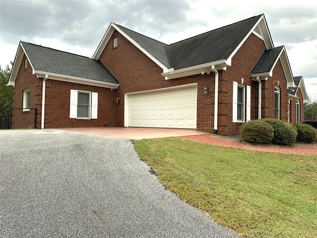 view of front facade with a front yard and a garage