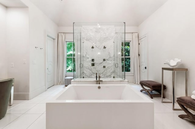 bathroom with plenty of natural light, tile patterned floors, a shower stall, and a garden tub