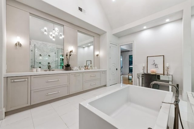 full bathroom with vaulted ceiling, a stall shower, double vanity, a soaking tub, and a chandelier