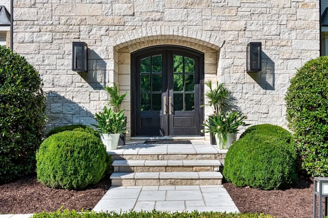 doorway to property with french doors and stone siding