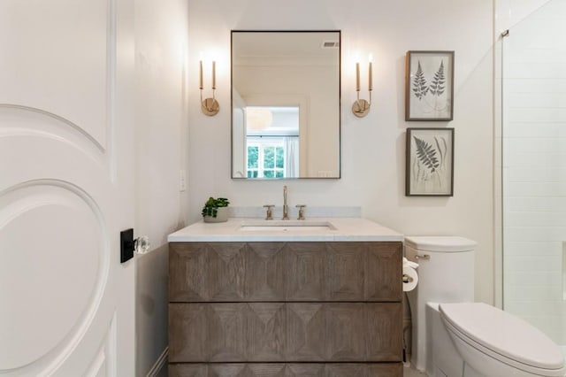 bathroom featuring toilet and vanity