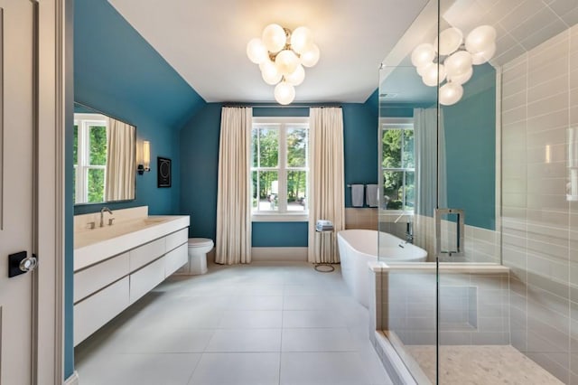 full bath featuring a chandelier, vanity, a freestanding bath, vaulted ceiling, and tile patterned flooring